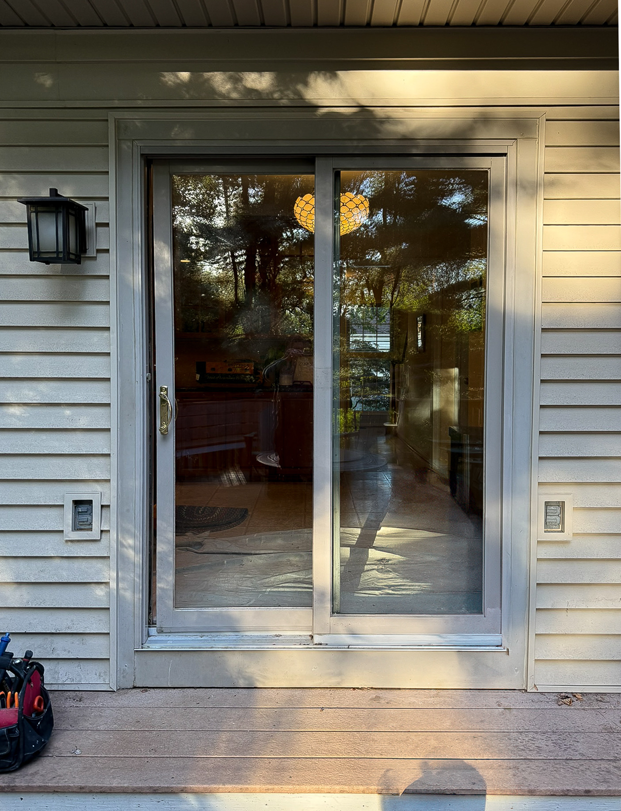 Patio Door Replacement and Wall Dog Door Installation before 0 photo.