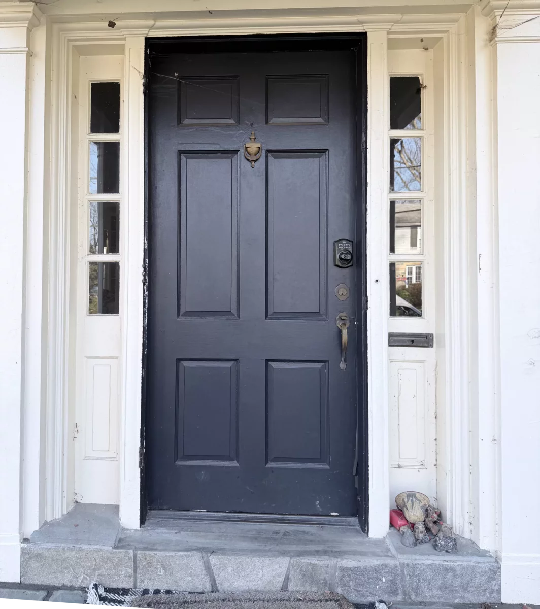 Front exterior door with sidelights and visible wear