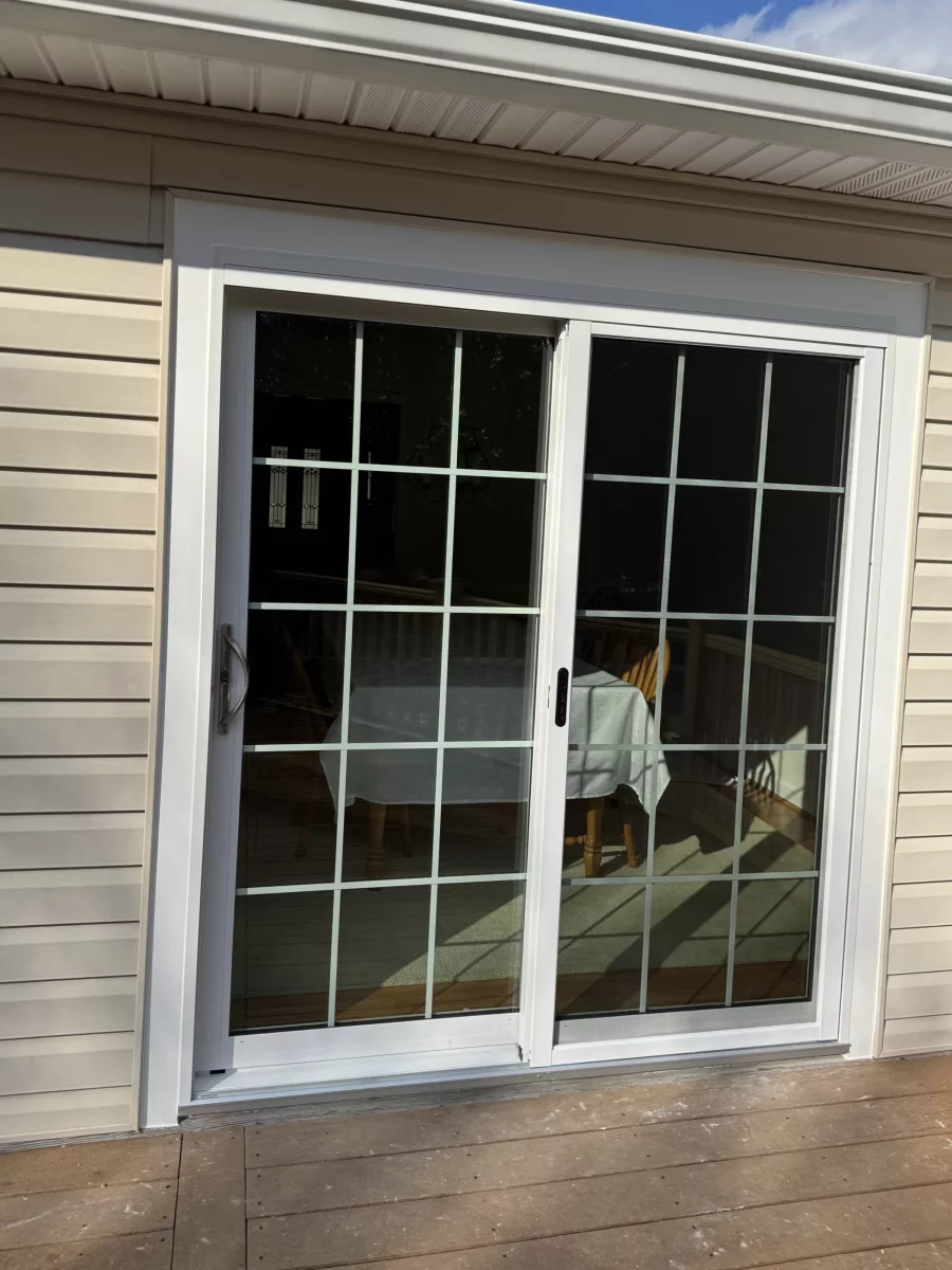White vinyl sliding patio door with grids inside the glass