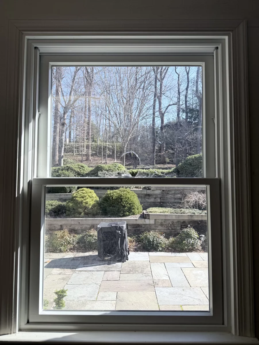 Double-hung window with white trim viewed from inside