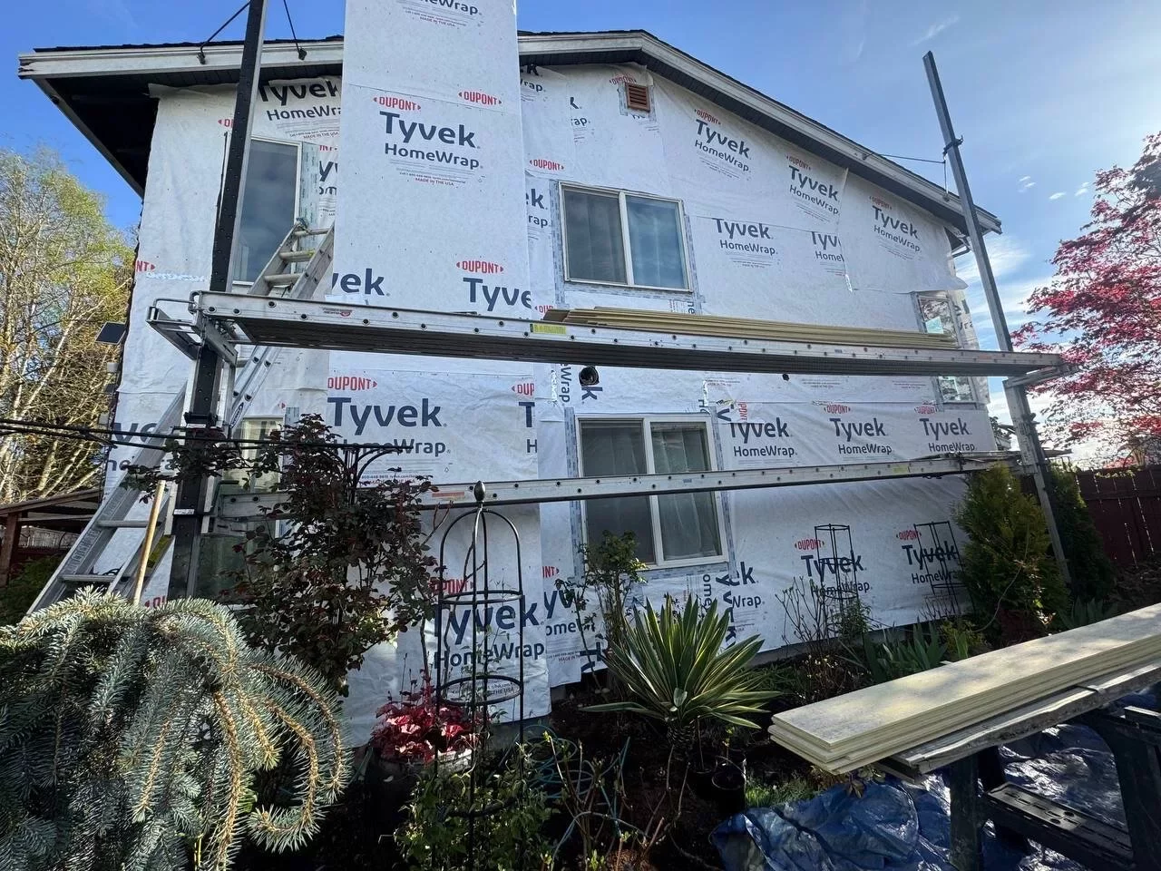 Everett home wrapped in Tyvek house wrap with windows during siding installation