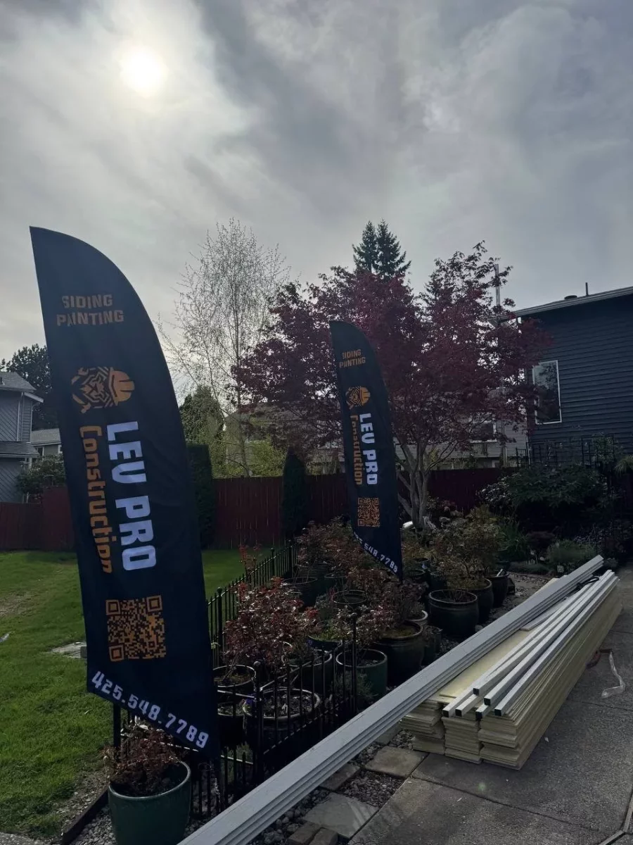 Completed exterior siding and painting project in Everett, WA with company banner on site